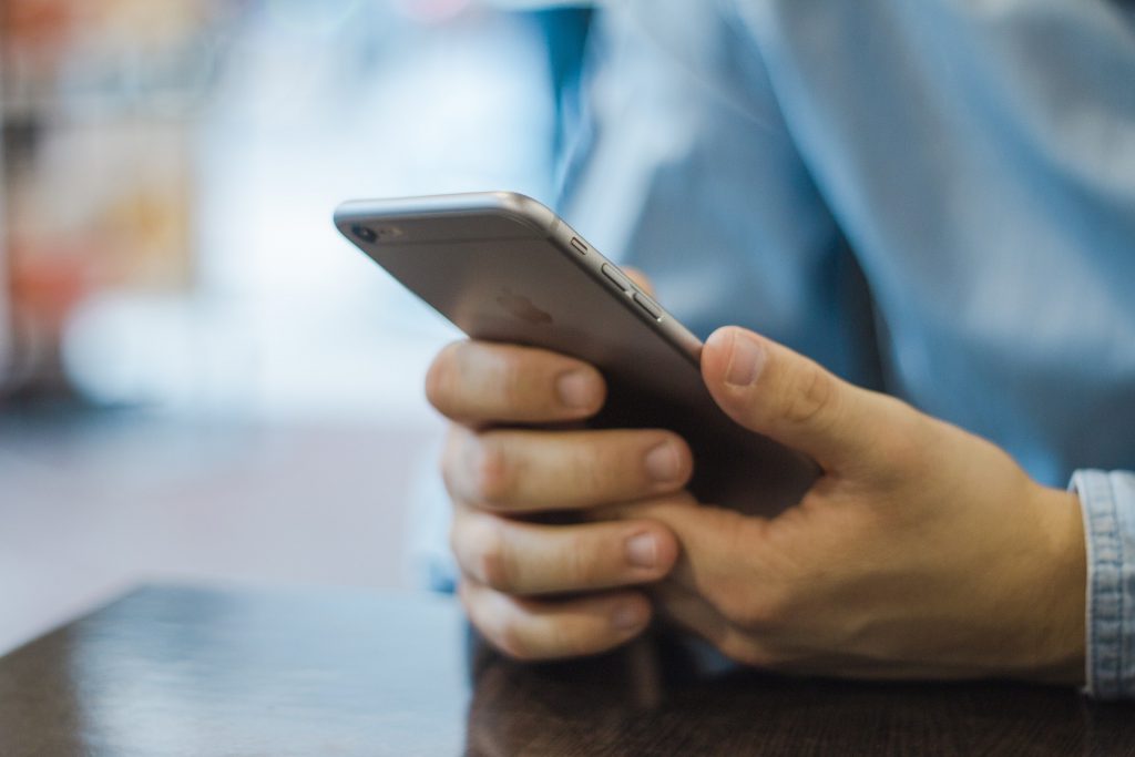 Man Holding Phone in Hands Stock Photo